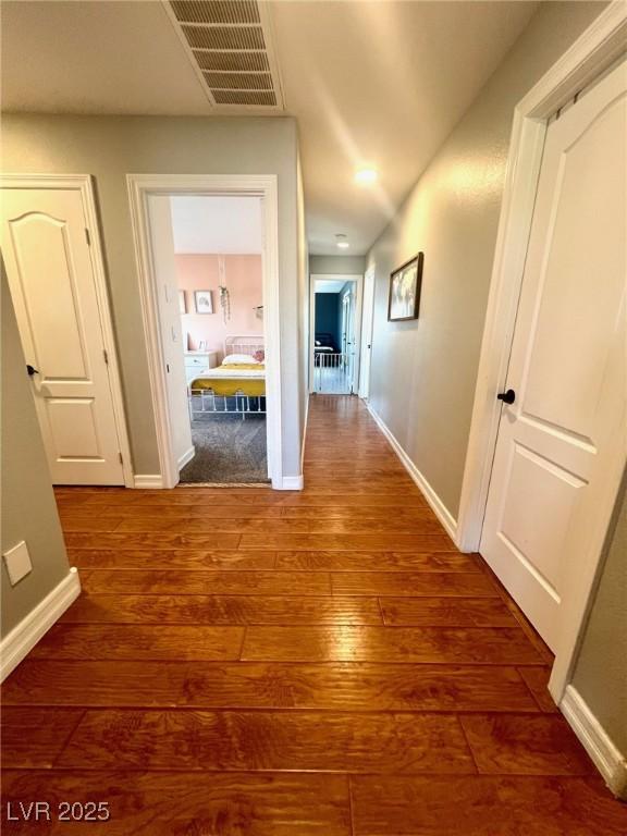 hall with dark hardwood / wood-style flooring