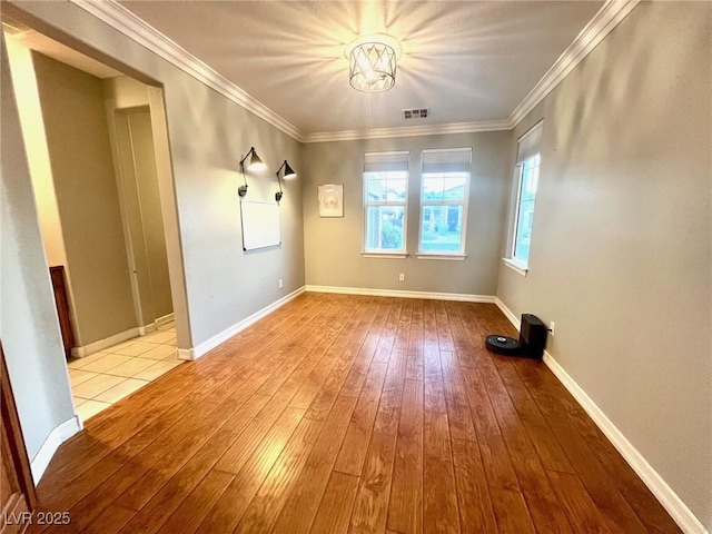 unfurnished room featuring crown molding and light hardwood / wood-style flooring