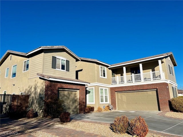 view of front of property featuring a balcony and a garage