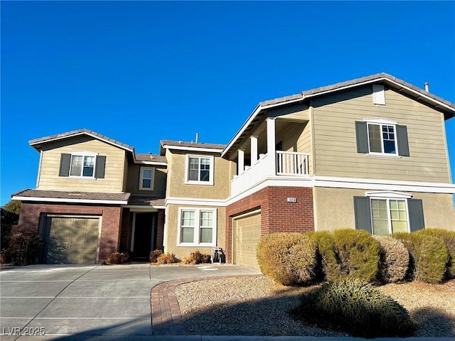 front facade with a garage and a balcony