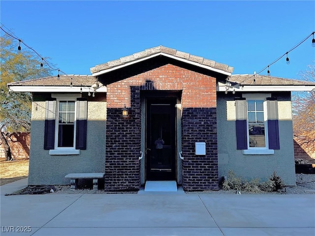 bungalow-style home with a patio area