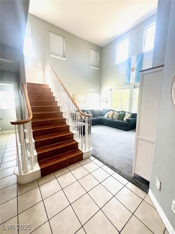 interior space with carpet and a towering ceiling