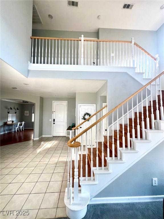 stairs featuring tile patterned flooring