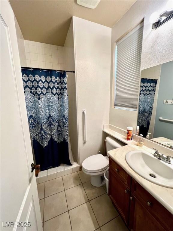 bathroom with vanity, tile patterned floors, and toilet