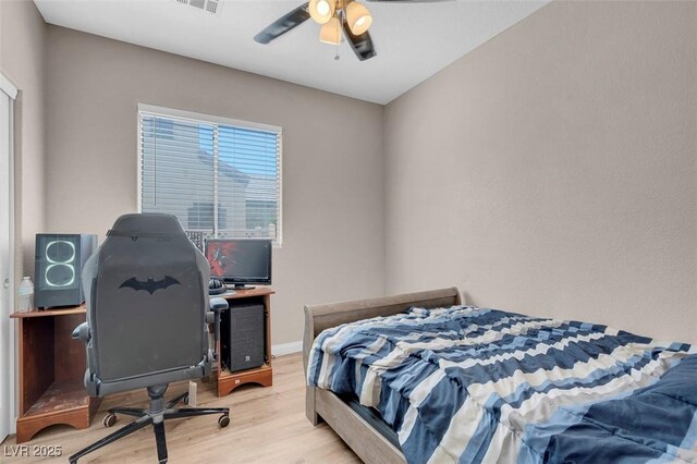 bedroom with ceiling fan and light hardwood / wood-style flooring