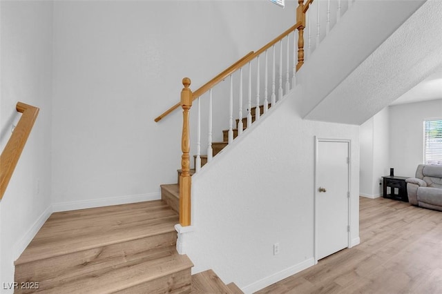 stairs featuring hardwood / wood-style floors