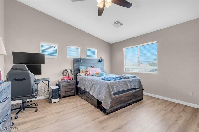 bedroom featuring light hardwood / wood-style floors, vaulted ceiling, and ceiling fan