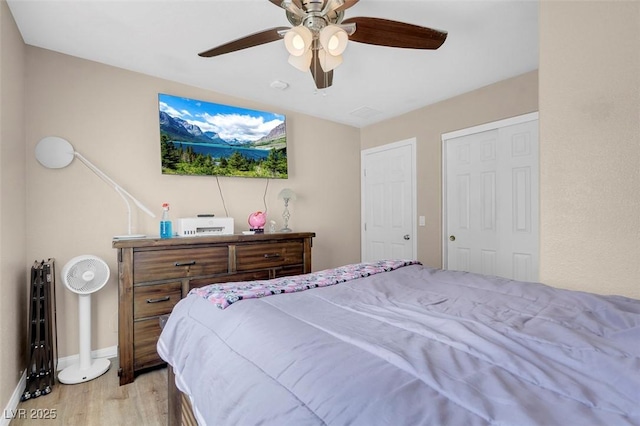 bedroom with ceiling fan and light hardwood / wood-style flooring