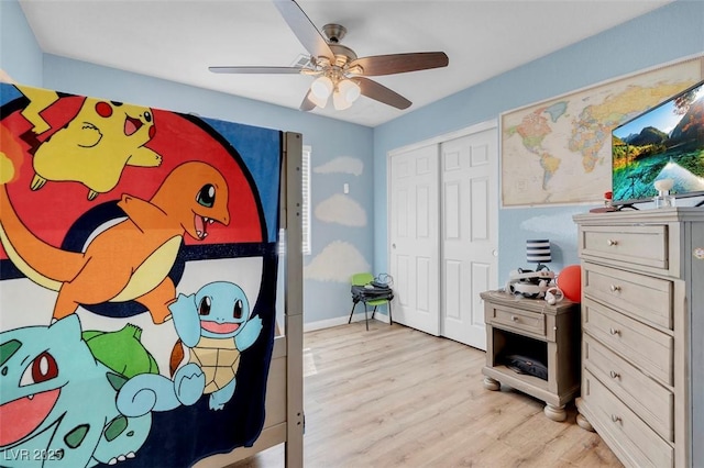 bedroom featuring ceiling fan, a closet, and light wood-type flooring