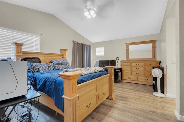 bedroom with ceiling fan, light wood-type flooring, and lofted ceiling