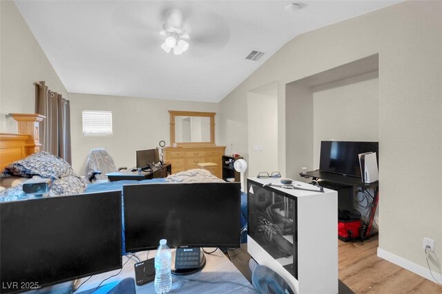 bedroom featuring ceiling fan, light hardwood / wood-style flooring, and vaulted ceiling