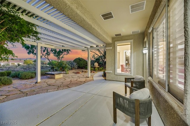 view of patio terrace at dusk