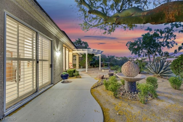 patio terrace at dusk with a pergola