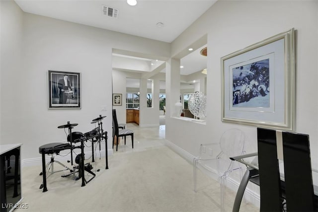 hallway with beverage cooler and light carpet