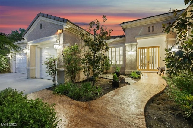 view of front of house featuring a garage and french doors