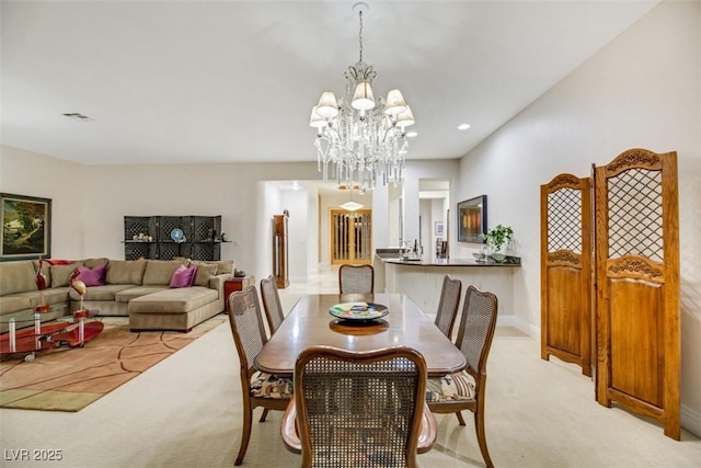 carpeted dining space with a notable chandelier