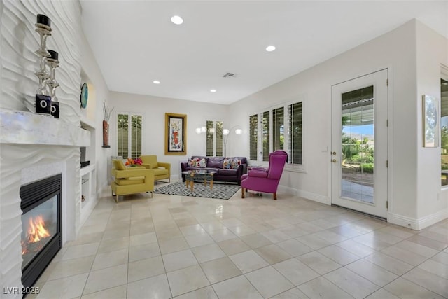 tiled living room with built in features and a healthy amount of sunlight