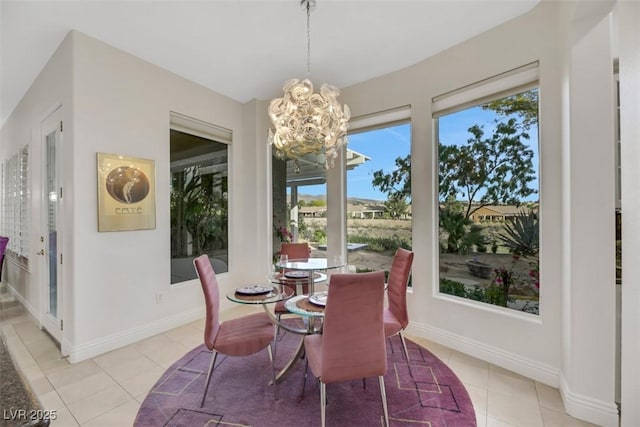 dining room featuring light tile patterned floors and a chandelier