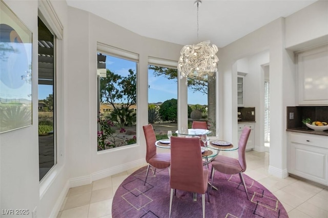 dining area with light tile patterned floors and a chandelier