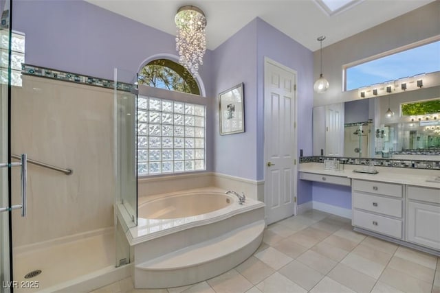 bathroom featuring tile patterned floors, vanity, independent shower and bath, and a wealth of natural light