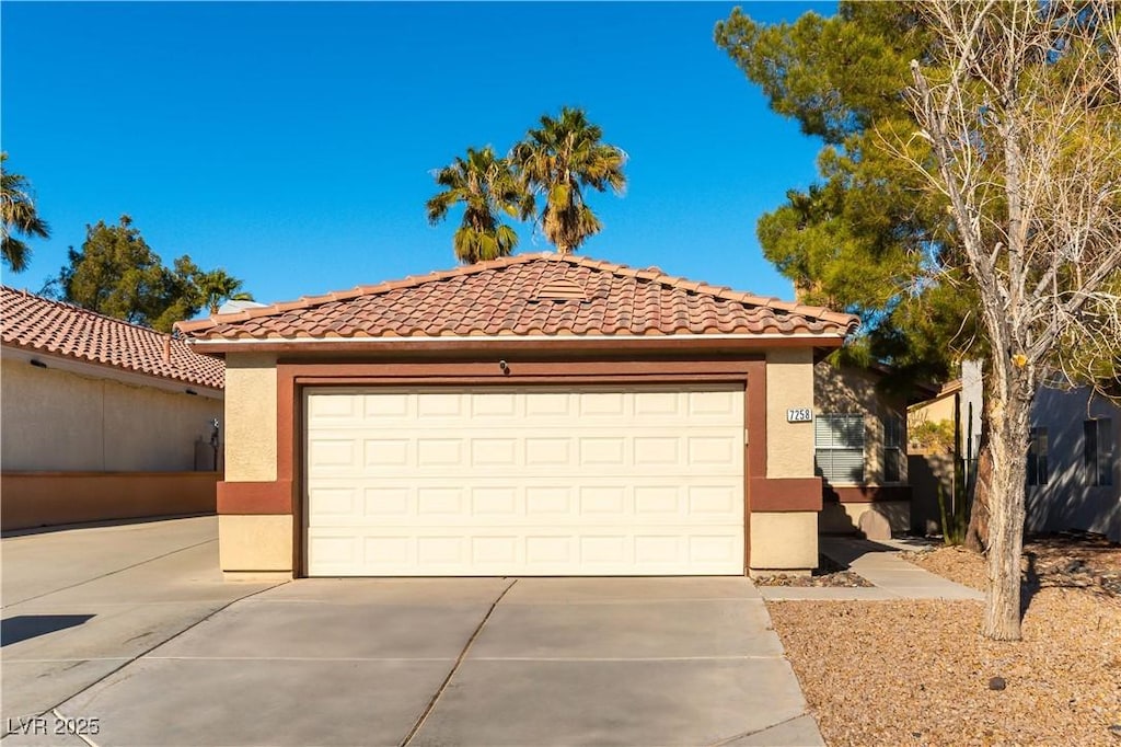 mediterranean / spanish-style home with an outdoor structure and a garage