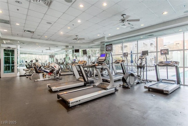 gym featuring a paneled ceiling, plenty of natural light, and visible vents