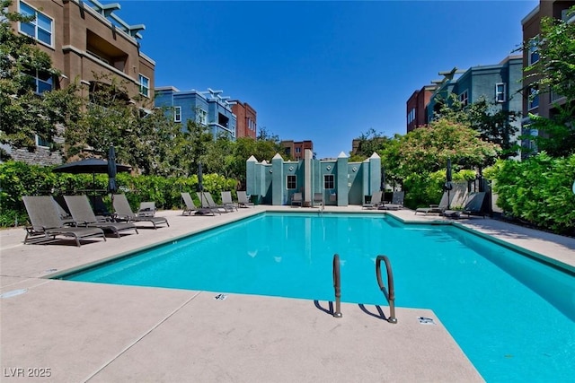 community pool featuring a patio area and a residential view