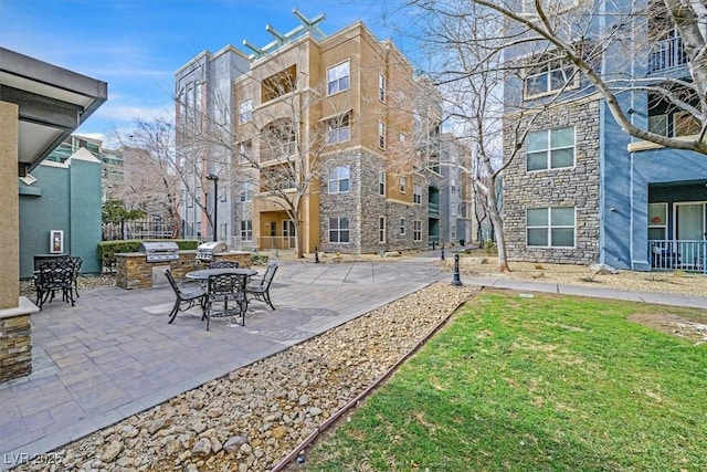 exterior space featuring a patio area, a lawn, and area for grilling