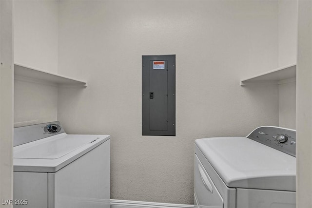 laundry area featuring laundry area, separate washer and dryer, electric panel, and baseboards