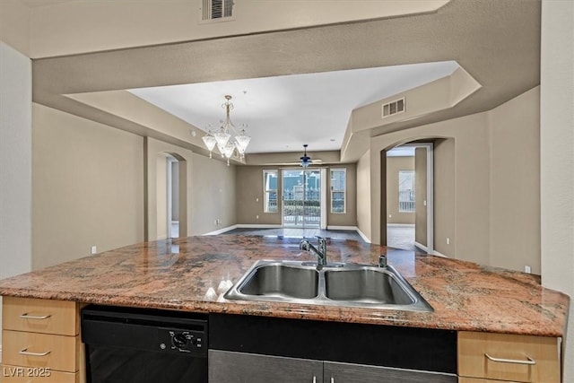 kitchen with arched walkways, visible vents, open floor plan, a sink, and dishwasher