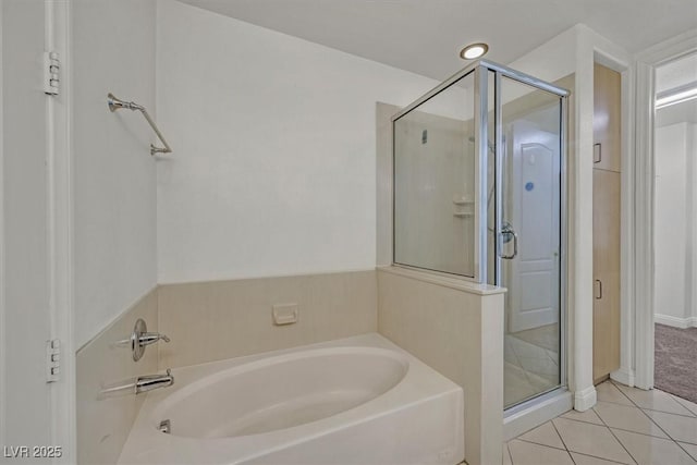 full bathroom with tile patterned flooring, a bath, and a shower stall