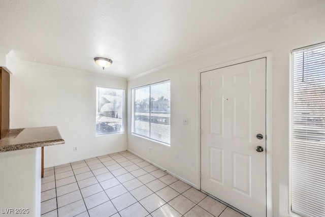 tiled entrance foyer featuring ornamental molding