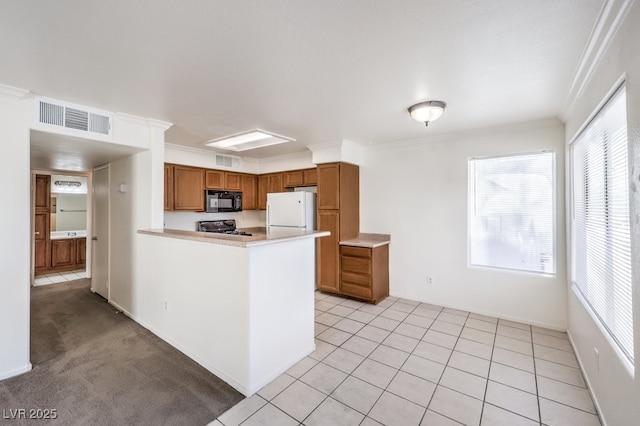 kitchen with ornamental molding, white refrigerator, stove, and light tile patterned floors