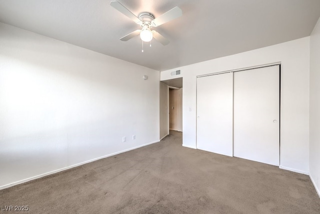 unfurnished bedroom with a closet, ceiling fan, and carpet