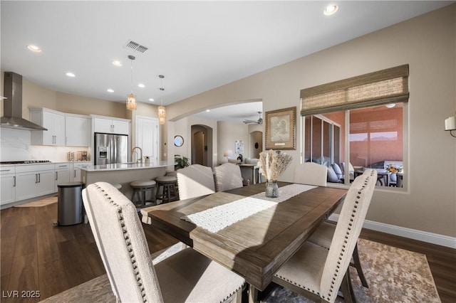 dining space featuring dark hardwood / wood-style flooring and sink