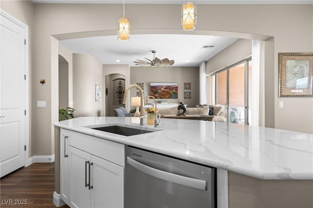 kitchen featuring dishwasher, white cabinets, sink, hanging light fixtures, and ceiling fan