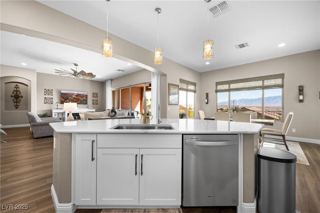 kitchen featuring ceiling fan, stainless steel dishwasher, dark hardwood / wood-style floors, pendant lighting, and white cabinets