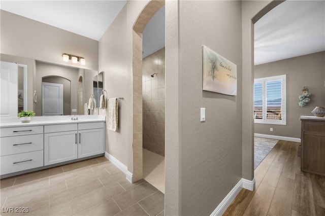 bathroom featuring vanity and tiled shower