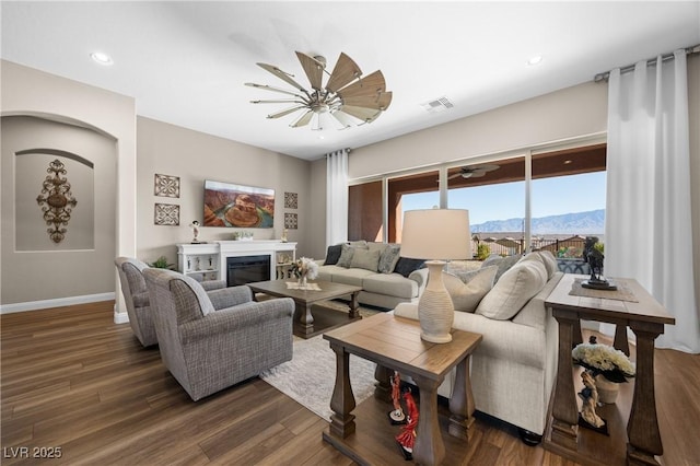 living room with a mountain view and dark wood-type flooring