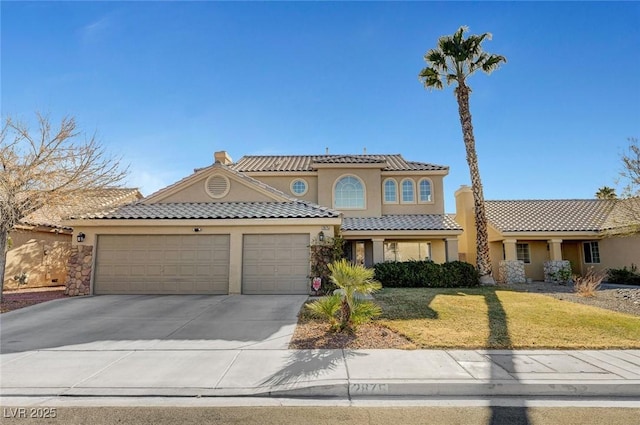 mediterranean / spanish-style house featuring a garage and a front lawn