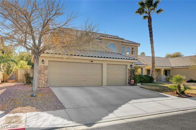 mediterranean / spanish home with a garage