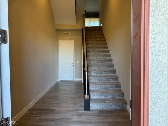 stairway with hardwood / wood-style floors