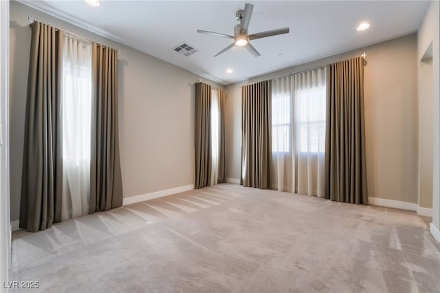 unfurnished room featuring light carpet and ceiling fan