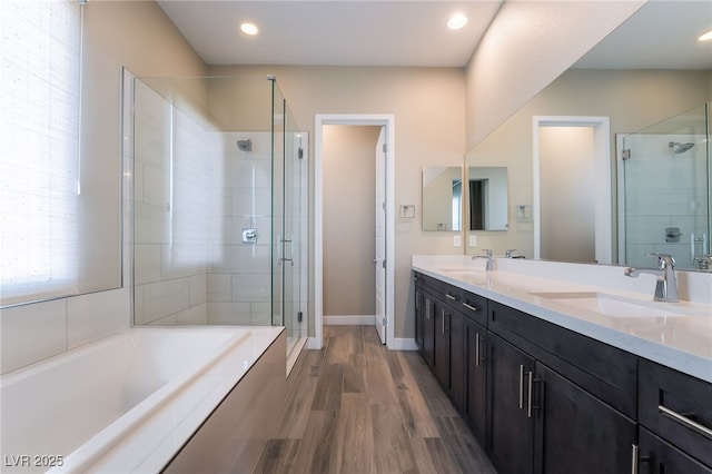 bathroom featuring vanity, plus walk in shower, and hardwood / wood-style floors