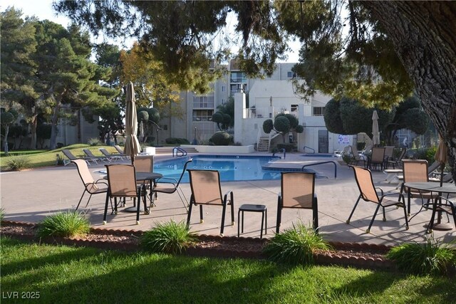 community pool featuring a patio area and fence