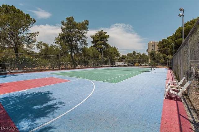 view of sport court with a tennis court, community basketball court, and fence