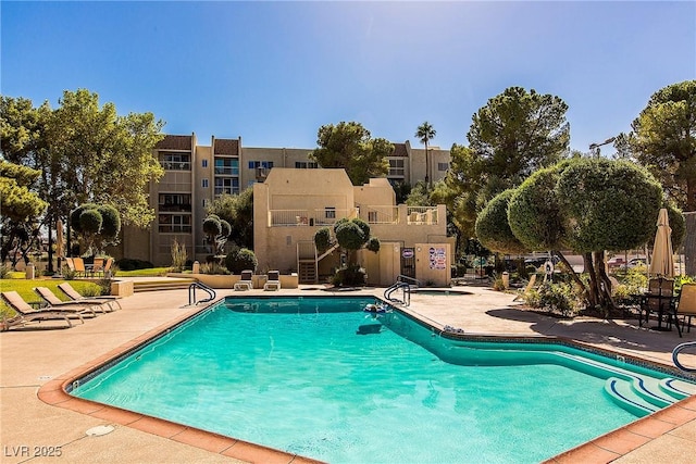 pool with stairs and a patio