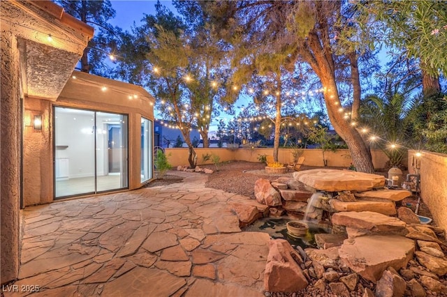 view of patio terrace at dusk