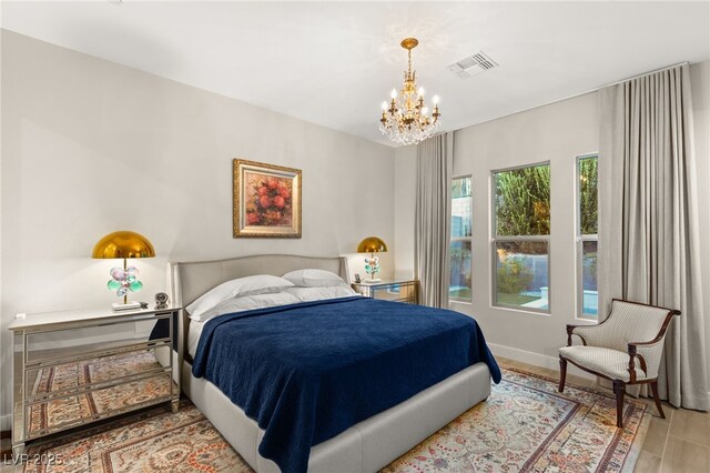 bedroom featuring a notable chandelier