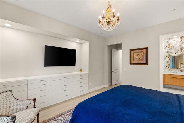 bedroom featuring a chandelier and ensuite bath